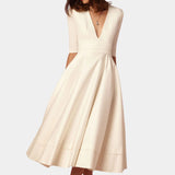 Ivory elegant A-line midi dress with a formal boat neck and half sleeves, in beige color and extra-large size, highlighting the waist with a sophisticated design.