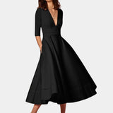 
A black A-line midi dress featuring a formal boat neck and half sleeves, suitable for elegant occasions.
