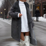 Ivory faux shearling winter coat in gray, featuring a double-breasted design with an oversized fit. The coat has a stylish collar, long sleeves, and reaches knee-length, embodying a fashionable and cozy look for cold weather.
