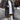 Ivory faux shearling winter coat in gray, featuring a double-breasted design with an oversized fit. The coat has a stylish collar, long sleeves, and reaches knee-length, embodying a fashionable and cozy look for cold weather.