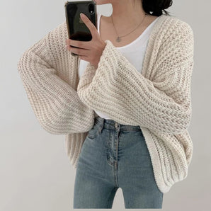 Women's ivory oversized chunky knit cardigan sweater, featuring a cozy fall fashion design with long sleeves and a soft texture.