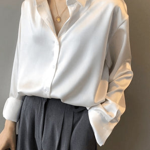 Ivory oversized silk blouse featuring a luxury satin finish with a loose fit, long sleeves, and a classic collar, perfect for an elegant office look.