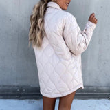 Ivory oversized women's puffy winter jacket with a lightweight quilted design, displayed on a model showcasing the coat's outerwear features and its white color.