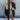 Oversized women's puffy winter jacket in black with a quilted design, featuring a high neck and long sleeves, styled for fashion and cold weather comfort.