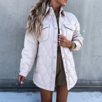 Ivory oversized women's puffy winter jacket in XL size, featuring a lightweight quilted design with long sleeves and a high neckline, displayed on a model.