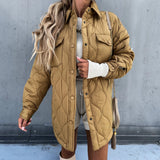Ivory oversized women's puffy winter jacket in khaki, size XL, featuring lightweight quilted design with long sleeves, shown on a model wearing sunglasses.
