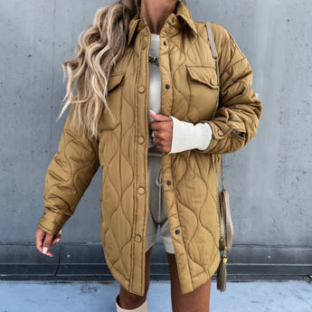 Ivory oversized women's puffy winter jacket in khaki, size XL, featuring lightweight quilted design with long sleeves, shown on a model wearing sunglasses.
