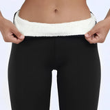 
A pair of tall black fur boots with ivory plush lining designed for women, showcasing a luxurious winter fashion style.