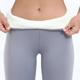 Ivory plush lined tall fur boots in light grey, designed for women, displayed in a winter setting. The luxurious boots feature a soft fur lining and tall design, suitable for winter wear.