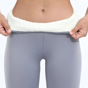 Ivory plush lined tall fur boots in light grey, designed for women, displayed in a winter setting. The luxurious boots feature a soft fur lining and tall design, suitable for winter wear.