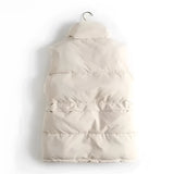 Ivory quilted sleeveless lightweight puffer vest hanging on a clothes hanger, showcasing winter fashion style.