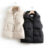 Ivory quilted sleeveless lightweight puffer vest with a high collar, showcasing a stylish winter fashion look.