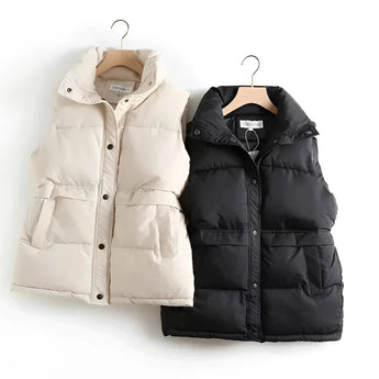 Ivory quilted sleeveless lightweight puffer vest with a high collar, showcasing a stylish winter fashion look.