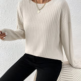 Ivory ribbed crew neck women's sweater with long sleeves, showcasing a casual chic fall fashion style.