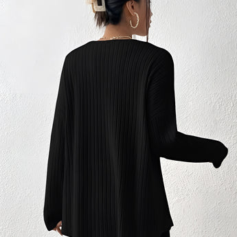 Ivory ribbed crew neck women's sweater with long sleeves, worn by a woman with shoulder-length hair, showcasing a casual yet chic fall fashion style.