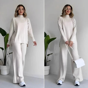 Ivory ribbed knit sweater and pants set displayed on a mannequin, showcasing the monochrome knitwear design with long sleeves and a high neckline.