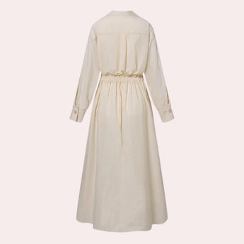 Ivory satin trench coat displayed on a mannequin, showcasing its elegant design with a collar, long sleeves, and a belted waist, resembling a stylish beige one-piece winter overcoat.