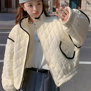 Ivory women's cropped quilted puffer jacket with contrast piping, shown in a gray-white color, size XL, featuring a stand collar and long sleeves.