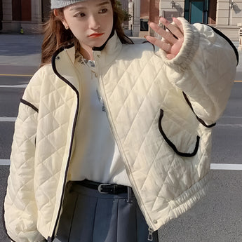 Ivory women's cropped quilted puffer jacket with contrast piping, shown in a gray-white color, size XL, featuring a stand collar and long sleeves.