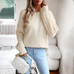 Ivory women's lightweight cable knit sweater featuring a stylish fall pullover design with long sleeves and a round neckline.