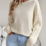 Ivory women's lightweight cable knit sweater in beige, shown in XL size, featuring a fashionable and stylish design ideal for fall. The pullover is worn by a model showcasing a trendy hairstyle and a relaxed pose, highlighting the sweater's texture and fit.