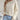Ivory women's lightweight cable knit sweater in beige, shown in XL size, featuring a fashionable and stylish design ideal for fall. The pullover is worn by a model showcasing a trendy hairstyle and a relaxed pose, highlighting the sweater's texture and fit.