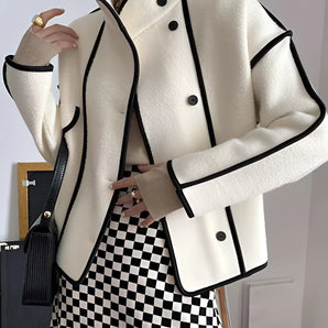Ivory wool jacket with black trim, featuring a double-breasted design and a high collar. The jacket has long sleeves and structured shoulders, offering a stylish and formal appearance.