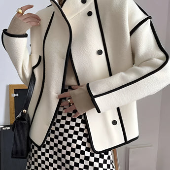 Ivory wool jacket with black trim, featuring a double-breasted design and a high collar. The jacket has long sleeves and structured shoulders, offering a stylish and formal appearance.