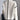 Ivory wool double-breasted jacket with black trim, featuring a high collar and long sleeves.