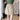 
A women's khaki A-line button-front mini skirt in beige, shown in size XL, styled as part of a casual spring fashion ensemble.
