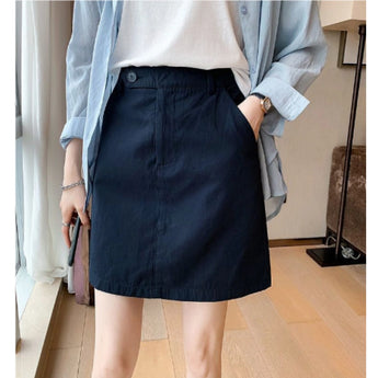 Women's blue A-line button-front mini skirt in XL, featuring a casual spring design. The skirt is paired with a dress shirt that has sleeves and a collar. The image also shows part of the human body from the waist to the knee and includes a bag as an accessory.