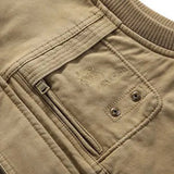 Men's lightweight khaki bomber jacket featuring a ribbed collar and snap button closure, displayed against a neutral background. The jacket has long sleeves and is made from a textile material in a khaki-beige color.