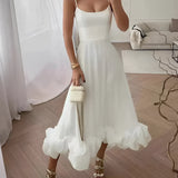 Elegant white maxi dress featuring spaghetti straps and a ruffled hem, suitable for formal occasions such as weddings; model is wearing a size XL.
