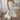 Elegant white maxi dress featuring spaghetti straps and a ruffled hem, suitable for formal occasions such as weddings; model is wearing a size XL.