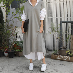 Sleeveless grey midi sweater dress with a V-neckline, featuring a layered design perfect for urban fashion.