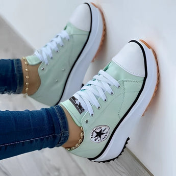 Women's green LED sneakers with neon soles, rechargeable, fashionable light-up shoes, size 43, worn with jeans.