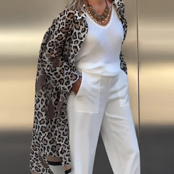 Leopard print cardigan paired with a stylish necklace, modeled by a woman over 50, showcasing chic fashion.