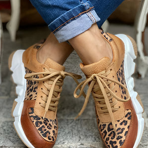 Leopard Print Chunky Sole Tan Leather Fashion Sneakers with a distinctive leopard pattern, featuring a thick white sole, shown worn on a person's feet.