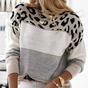 A trendy winter pullover sweater featuring a leopard print color block design. The knitwear displays a comfortable fit, with long sleeves and a round neckline, shown in a grey color scheme.