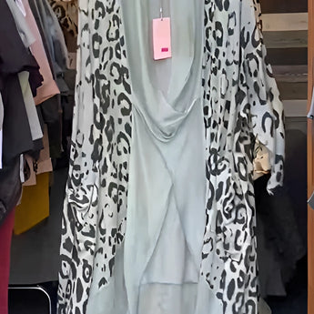Leopard print designer kimono in a foggy gray pattern, displayed on a clothes hanger, showcasing its long sleeves and open front design.