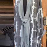 Leopard print designer kimono featuring a chic animal print in a gray tie-dye pattern, with wide sleeves and an open front, displayed on a clothes hanger.