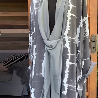 Leopard print designer kimono featuring a chic animal print in a gray tie-dye pattern, with wide sleeves and an open front, displayed on a clothes hanger.