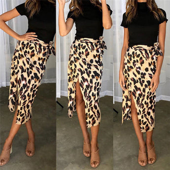 Leopard print high-waist midi skirt worn by a woman, paired with black shoes, showcasing trendy women's fashion.