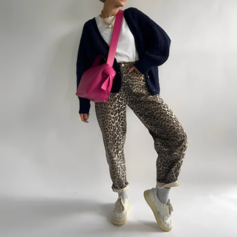 Leopard print jeans in XL size, featuring a trendy animal print design suitable for street style fashion. The pants showcase details like a fitted waist, comfortable thigh fit, and are styled for casual wear.