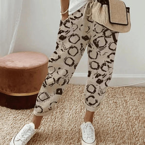 Leopard print joggers in beige with circular patterns, designed for women, shown in a 5XL size, featuring a stylish and comfortable loungewear fit.