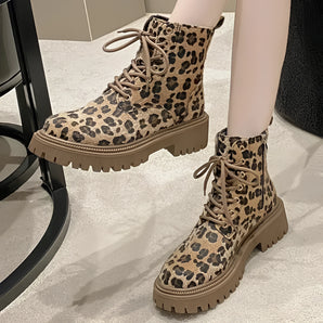 Leopard print lace-up women's combat boots featuring a chunky sole and fashionable design, showcasing a bold animal pattern.