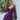 Leopard print open back mini dress with fashion pearl accessories, featuring a short-sleeved design and a chic purple color, worn by a person standing with visible arms and legs.