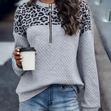 Women's chic streetwear gray half-zip pullover with leopard print, quilted design, worn by model with black hairstyle, showcasing shoulder and outerwear fashion.