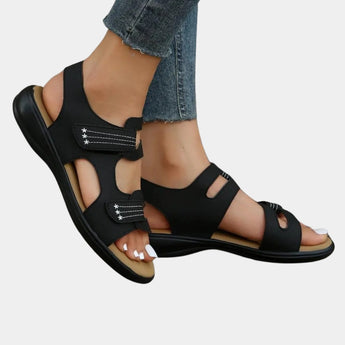 Leopard print slip-resistant women's sandals in black being worn on a model's feet, highlighting the trendy summer footwear design.