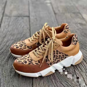 Leopard print women's fashion sneakers featuring a stylish and trendy design with a brown color scheme, suitable for outdoor activities and sportswear.